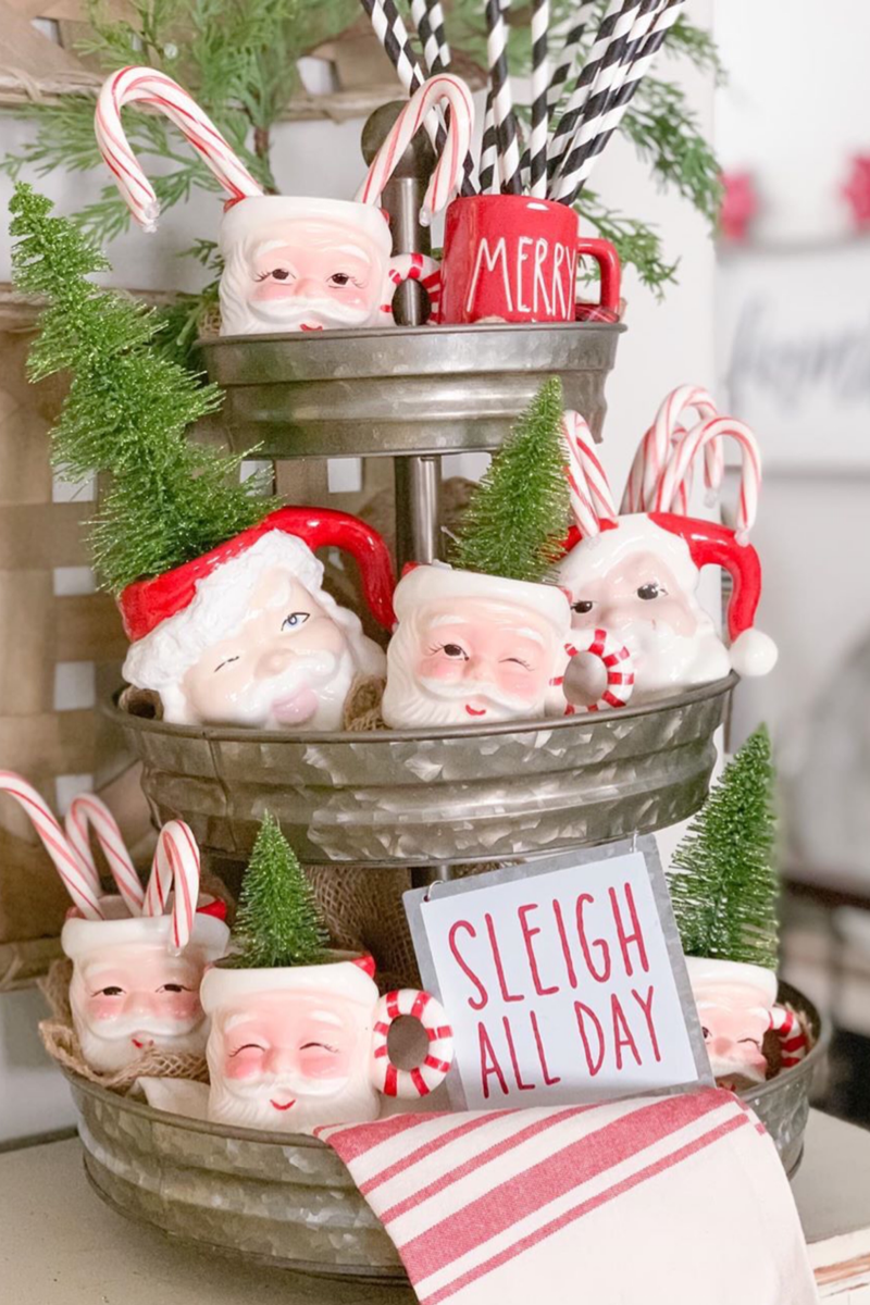 Galvonized three tiered Christmas tray filled with vintage looking Santa Claus mugs and candy canes via dogsndecor.com