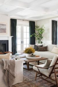 beautiful neutral living room with dark drapes white walls