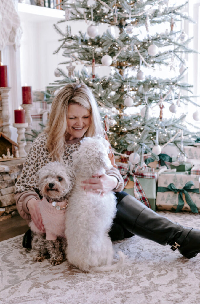 sparse king of christmas tree with blonde lady on the floor with two adorable pups